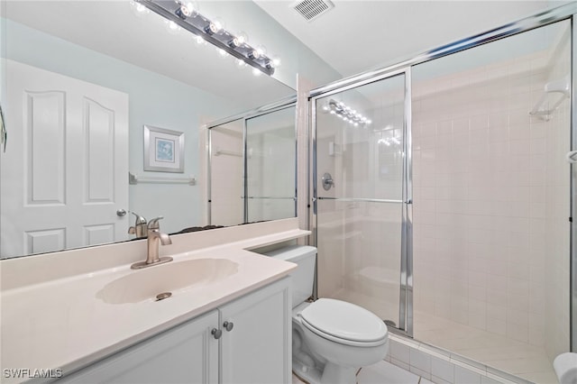 bathroom with a shower with door, vanity, and toilet