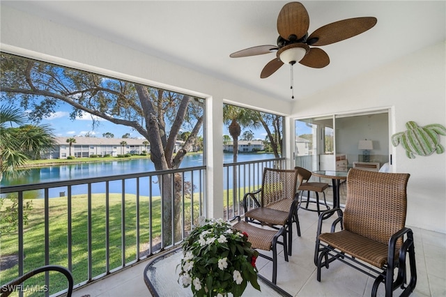 sunroom featuring plenty of natural light, a water view, and vaulted ceiling