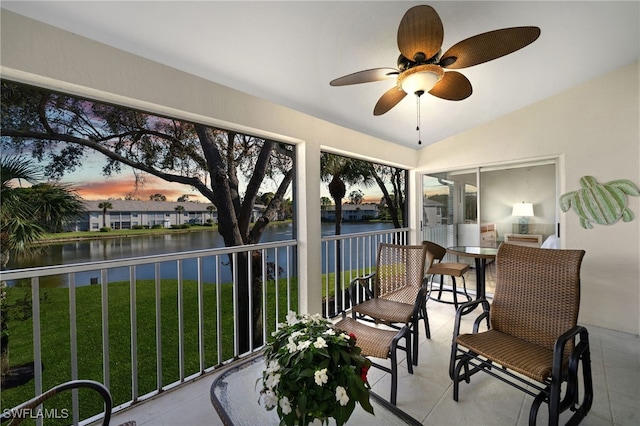 sunroom / solarium with a water view, ceiling fan, and lofted ceiling