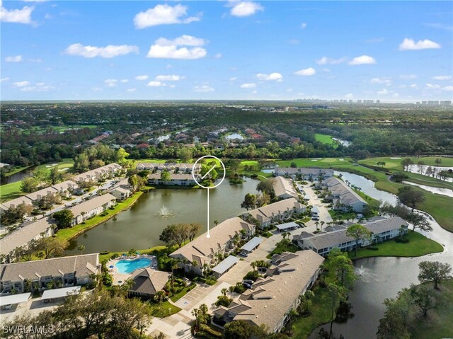 13120 Castle Harbour Dr Unit N4, Naples, FL 34110 - aerial overview of property's location featuring a large body of water, nearby suburban area, a tree filled landscape, and a pool