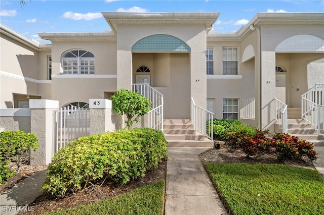 13120 Castle Harbour Dr Unit N4, Naples, FL 34110 - view of front of house featuring stairway and stucco siding