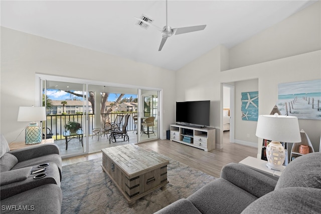 living room with ceiling fan, high vaulted ceiling, and hardwood / wood-style flooring