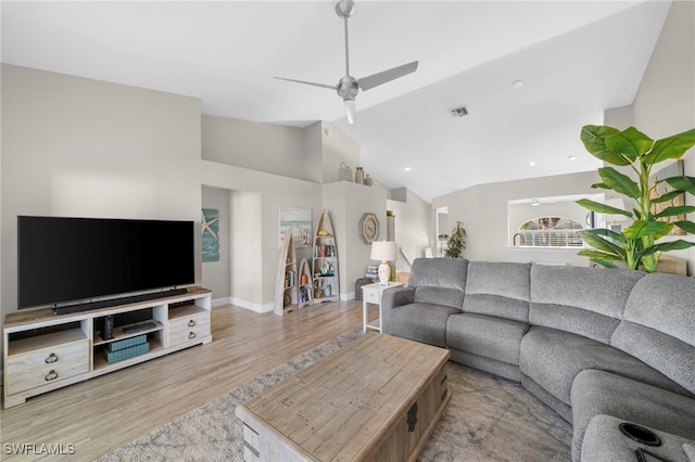 living room with ceiling fan, light wood-type flooring, and lofted ceiling