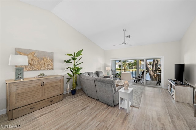 living room featuring ceiling fan, lofted ceiling, and light hardwood / wood-style flooring