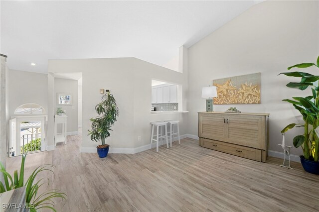 13120 Castle Harbour Dr Unit N4, Naples, FL 34110 - living area with wood finished floors, baseboards, recessed lighting, and a towering ceiling