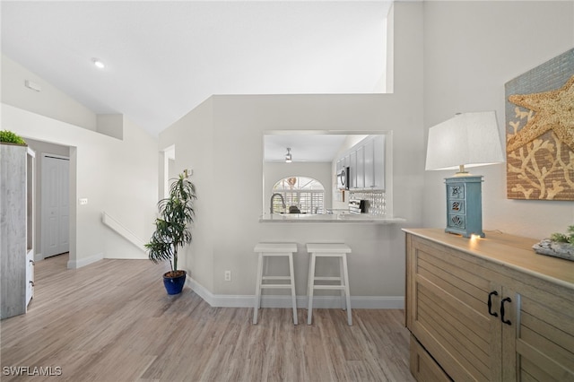 13120 Castle Harbour Dr Unit N4, Naples, FL 34110 - interior space featuring light wood-type flooring, a ceiling fan, high vaulted ceiling, and baseboards