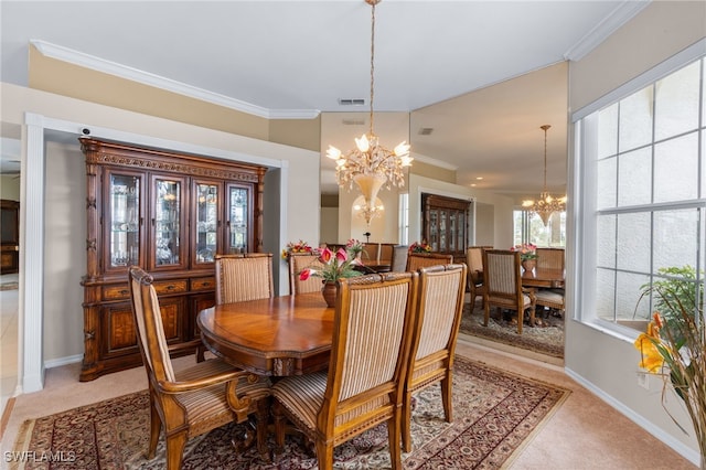 dining room with ornamental molding, light carpet, and a notable chandelier