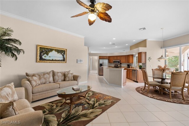 living room featuring ceiling fan, light tile patterned flooring, and crown molding