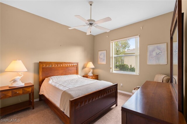 bedroom featuring ceiling fan and light carpet