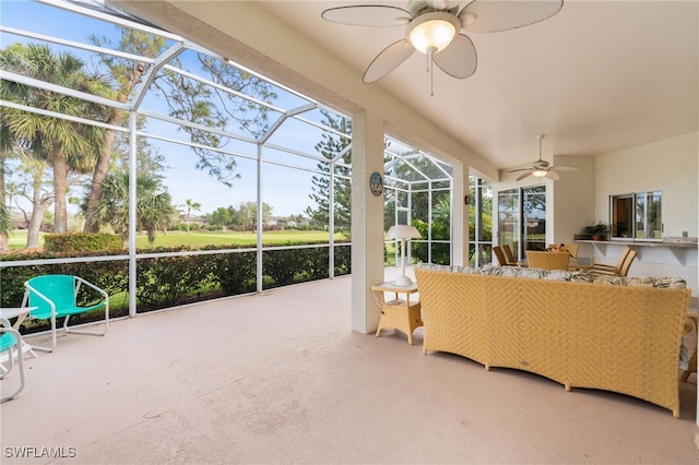 sunroom featuring ceiling fan