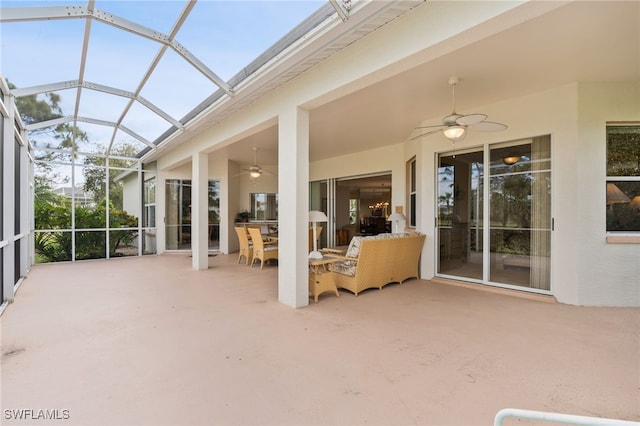 unfurnished sunroom with ceiling fan