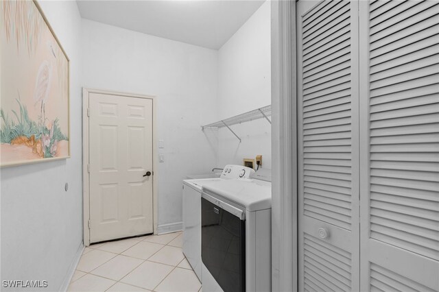 laundry room with washer hookup and light tile patterned flooring