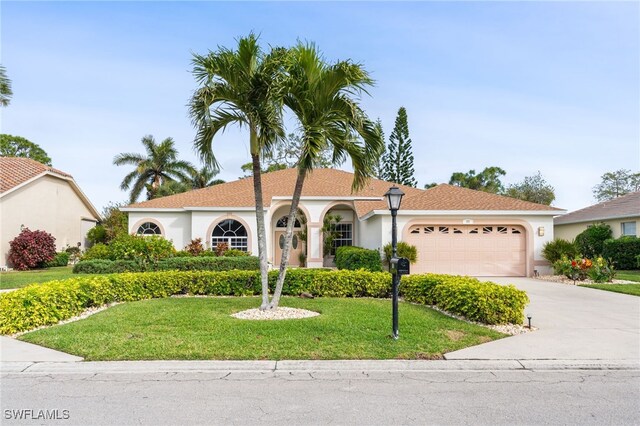 view of front of home with a garage and a front yard