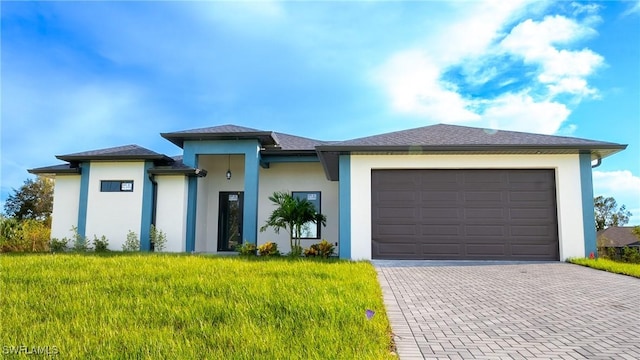 prairie-style home with a garage and a front lawn