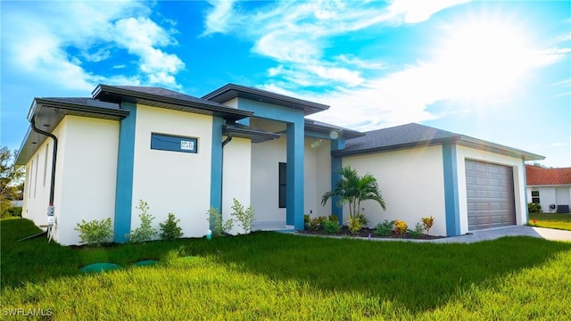 view of front of property with a garage and a front lawn