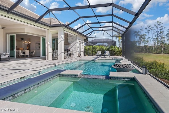 view of pool featuring a lanai, a patio area, and a pool with connected hot tub