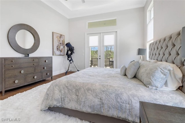 bedroom featuring access to outside, dark wood-type flooring, french doors, and baseboards