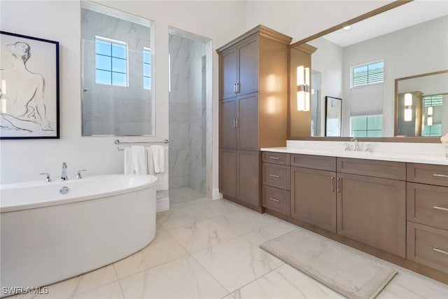 full bathroom with marble finish floor, a soaking tub, a marble finish shower, and vanity