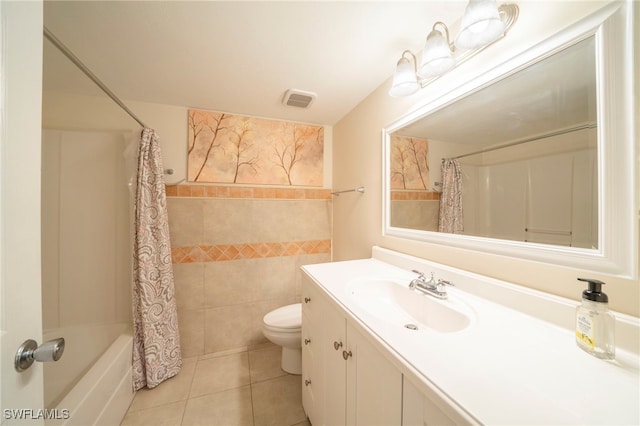 full bathroom featuring tile patterned floors, vanity, shower / tub combo with curtain, tile walls, and toilet