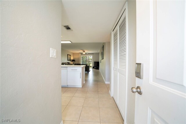 hallway featuring light tile patterned floors