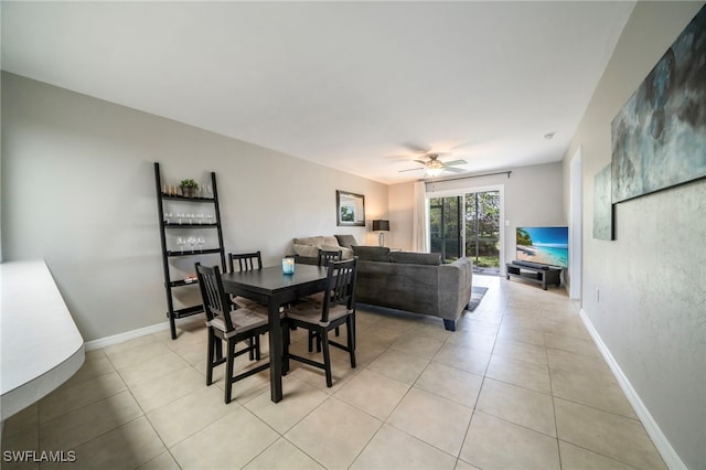 tiled dining room with ceiling fan