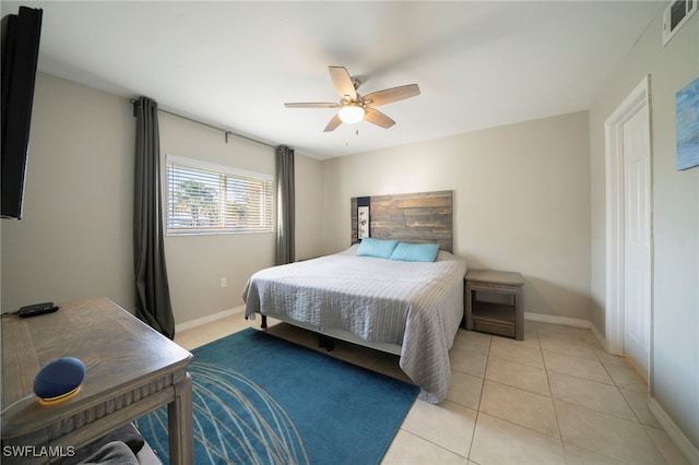 bedroom with ceiling fan and light tile patterned flooring