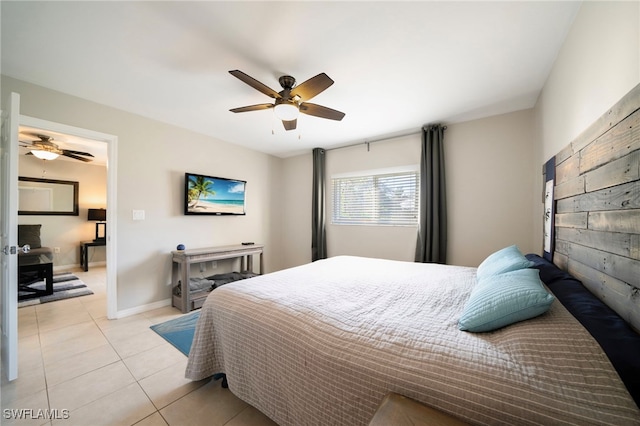 bedroom with ceiling fan and light tile patterned flooring