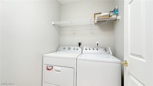 clothes washing area featuring washing machine and dryer