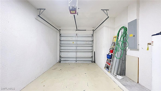 garage with a garage door opener and electric panel