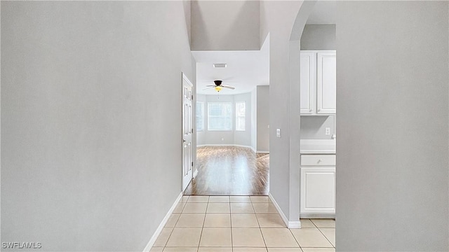 corridor featuring light tile patterned floors