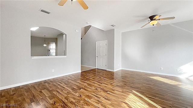 empty room featuring hardwood / wood-style flooring, ceiling fan, and sink