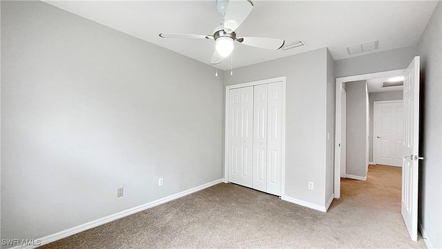 unfurnished bedroom featuring carpet flooring, ceiling fan, and a closet