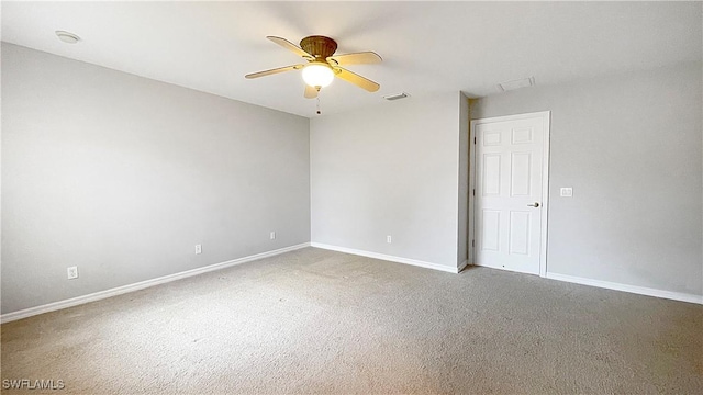 carpeted spare room with ceiling fan