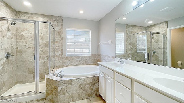 bathroom with tile patterned flooring, vanity, and shower with separate bathtub