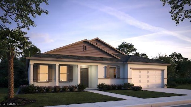 view of front facade featuring a garage and a yard