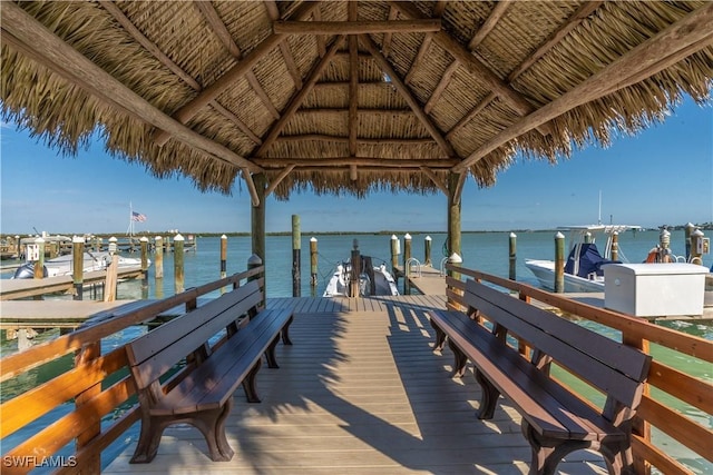 view of dock with a gazebo and a water view