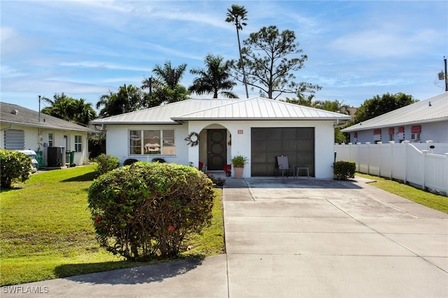 single story home featuring cooling unit and a front yard