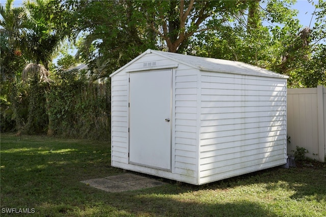 view of outbuilding featuring a lawn