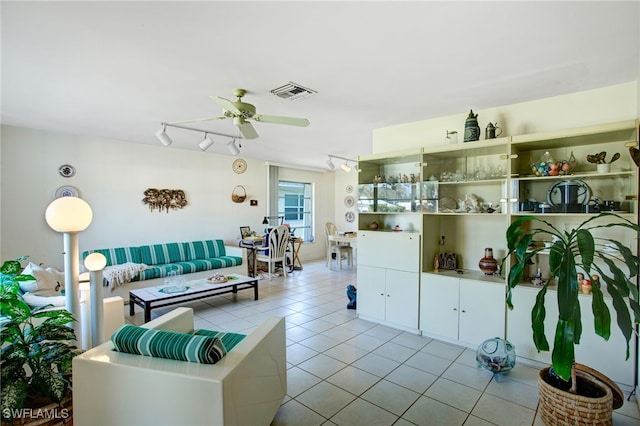 tiled living room with ceiling fan