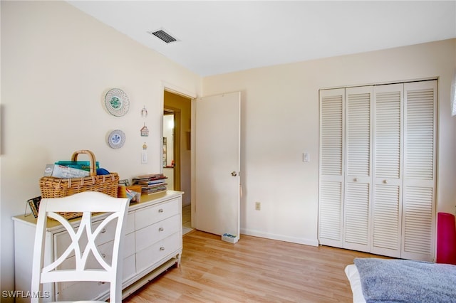 bedroom featuring a closet and light hardwood / wood-style flooring