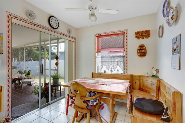 tiled dining space with ceiling fan