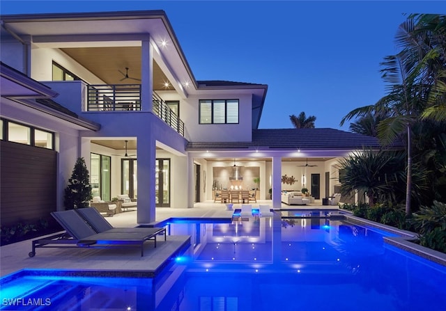 view of pool featuring outdoor lounge area, ceiling fan, and a patio area