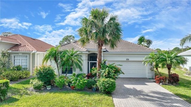 view of front of home featuring a front yard and a garage