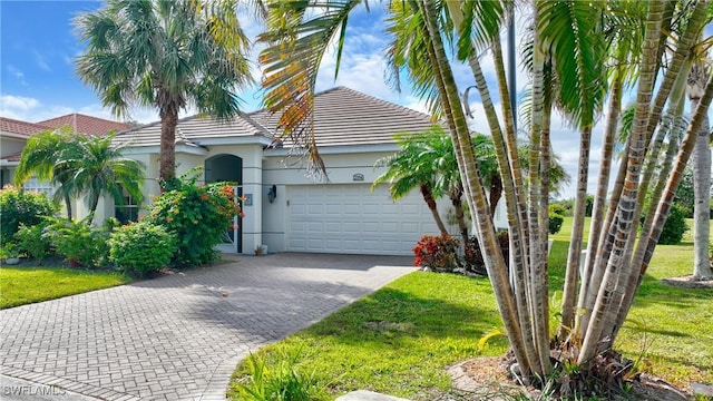 view of front of house featuring a front yard and a garage