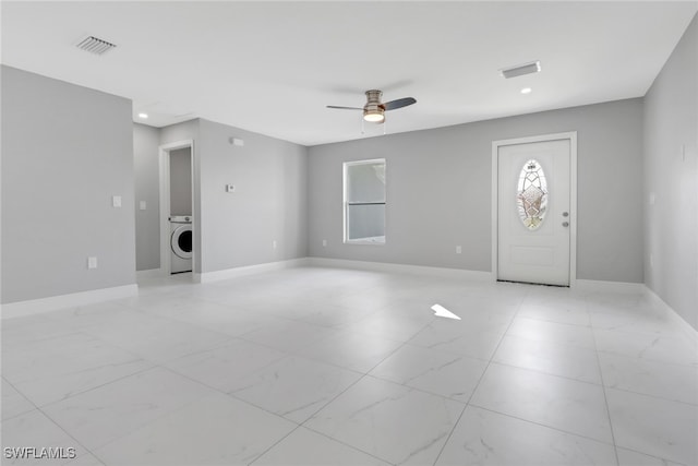 interior space with ceiling fan, visible vents, washer / clothes dryer, and baseboards