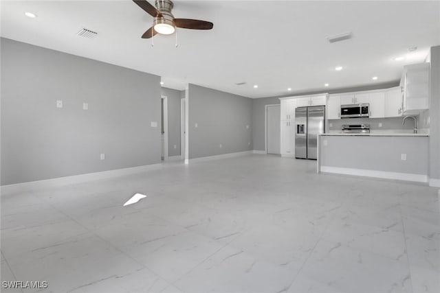 unfurnished living room with baseboards, ceiling fan, visible vents, and recessed lighting