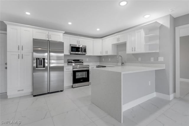 kitchen with appliances with stainless steel finishes, marble finish floor, light countertops, white cabinetry, and open shelves