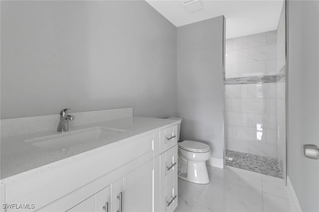 bathroom with marble finish floor, toilet, vanity, a walk in shower, and baseboards