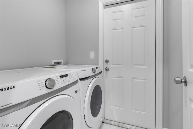 clothes washing area featuring laundry area and washing machine and dryer