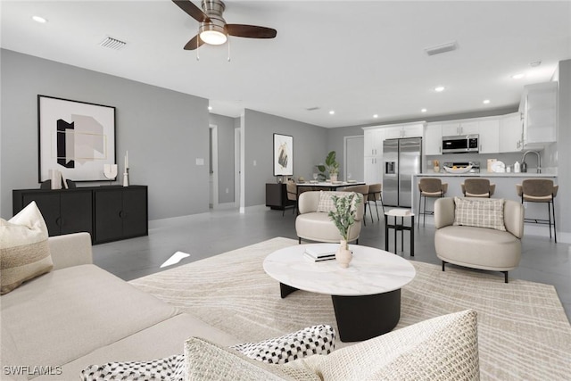 living room featuring ceiling fan, visible vents, and recessed lighting